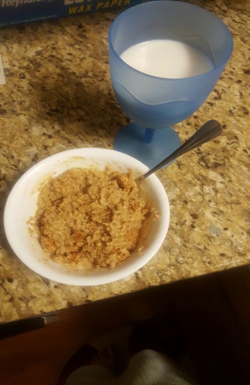 Yummy oatmeal breakfast with a cup of almond milk