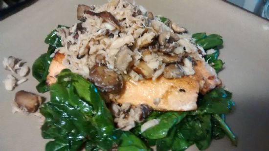 Crab topped salmon on bed of wilted spinach