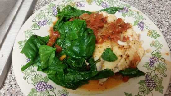 Fish with tomatoes orange and spinich