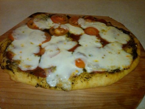Pizza with Pesto, Mozzarella, Pepperoni, Tomatoes