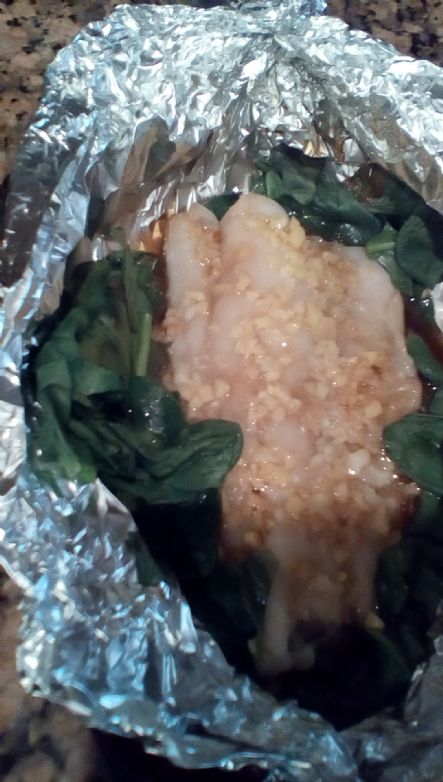 Gingered cod over wilted greens